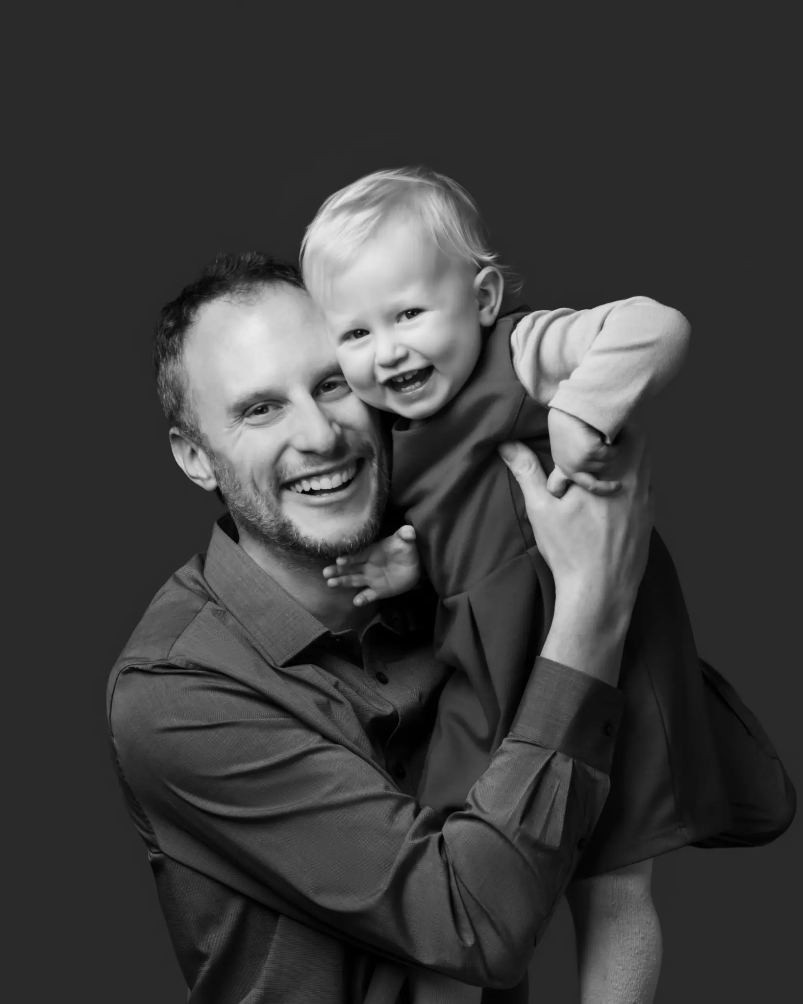 A black-and-white BP Portraits father-and-child portrait