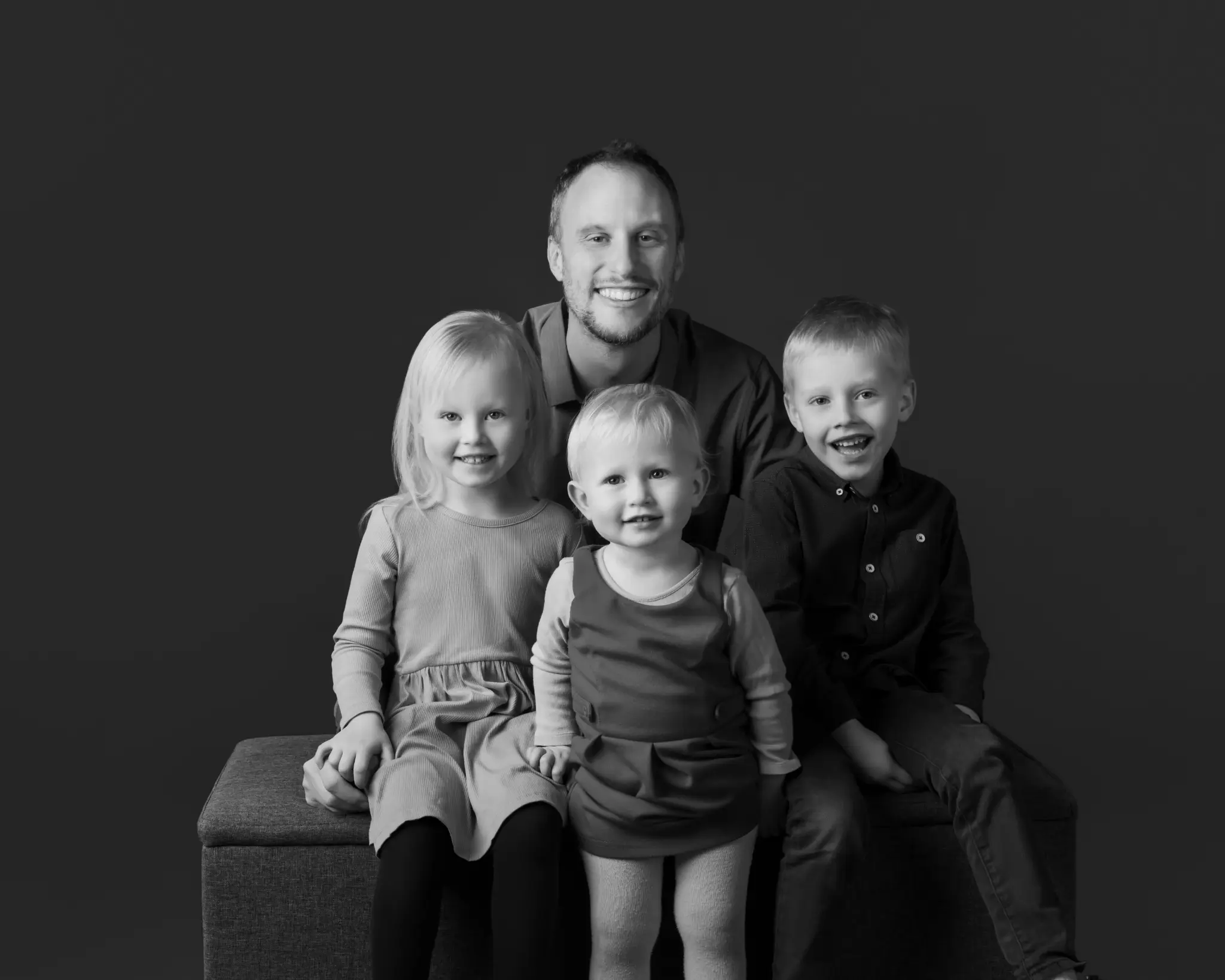 A black-and-white BP Portraits full family portrait